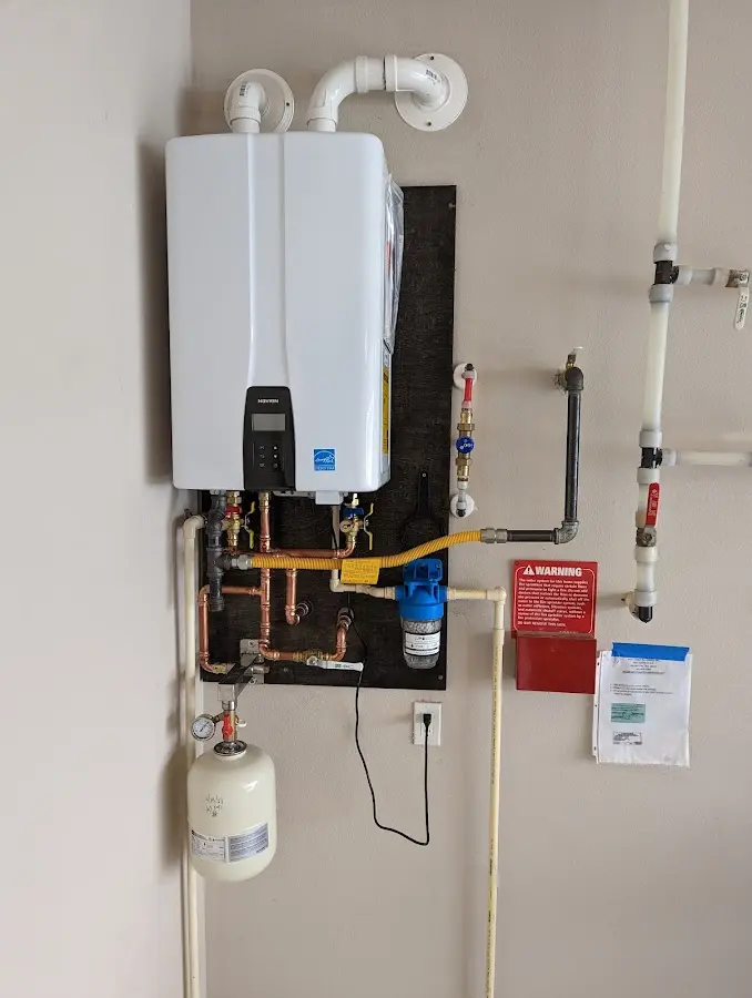 Professional plumber installing copper piping in a Lathrup Village home